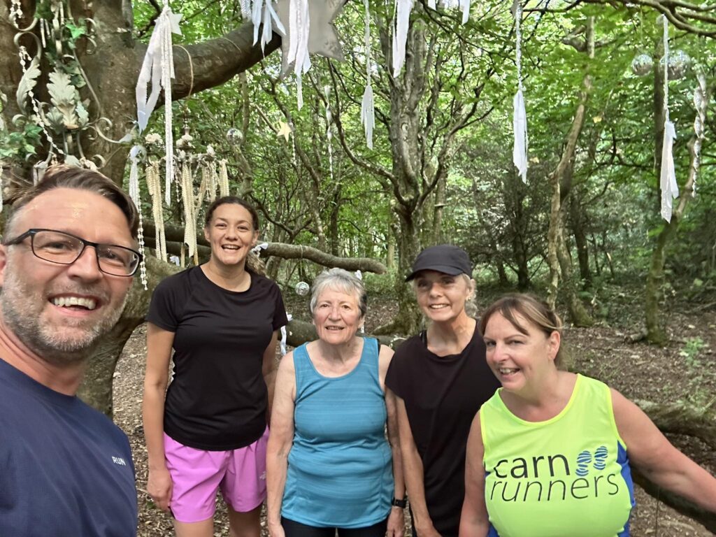 Carn Runners Friday group run in Tehidy Woods passing Rogue Theatre decorations