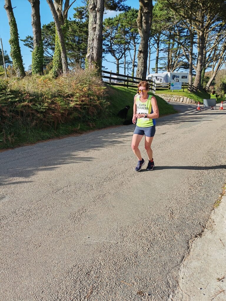 Carn Runners team at the Marazion 10K with Cornish coastline in the background