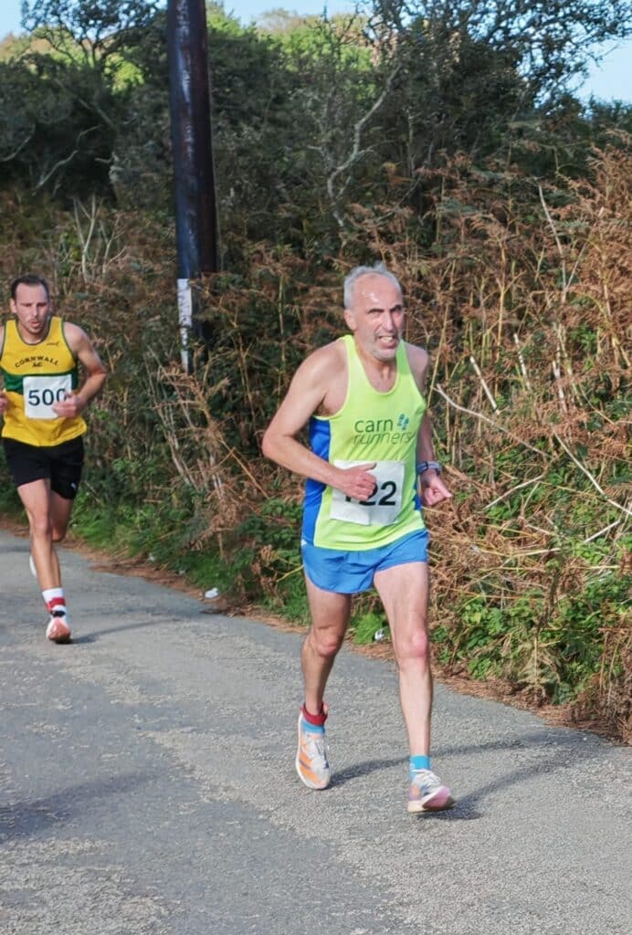 Carn Runners team at the Marazion 10K with Cornish coastline in the background