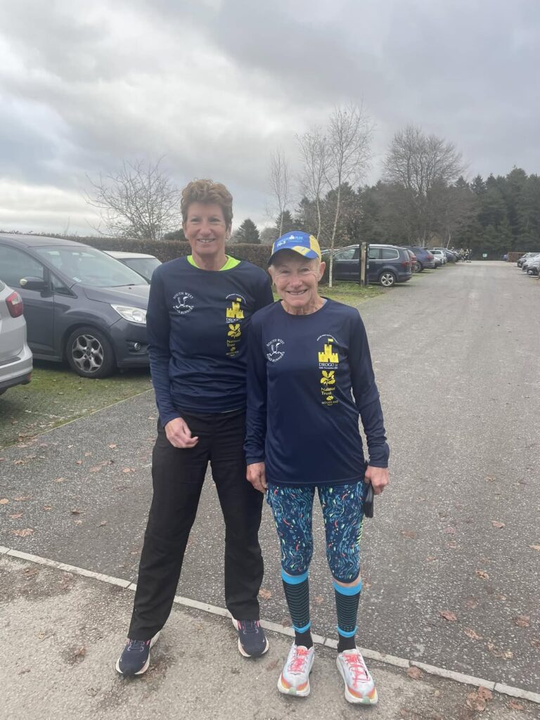 Two Carn Runners tackling a wet and hilly trail during the Drogo 10