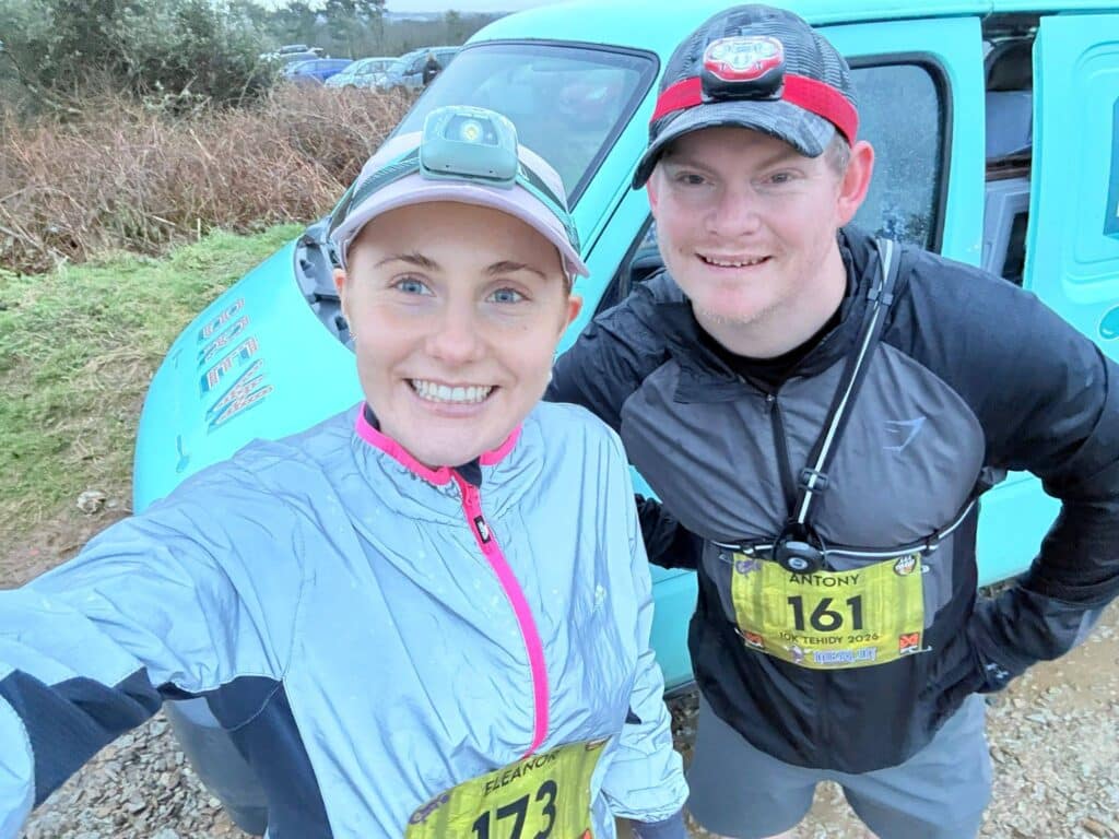 Antony and Eleanor Dennis running the Tehidy Twilight Run in wet muddy conditions at Tehidy Country Park