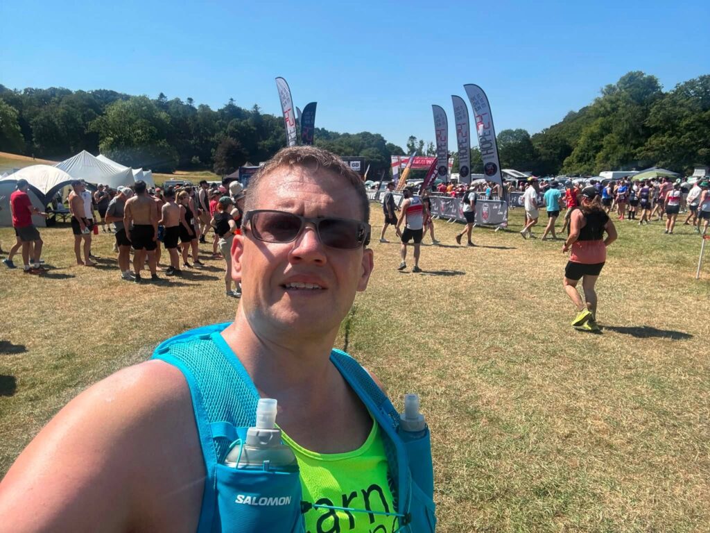 David Vaughan proudly displaying his Hope Trail Festival finisher's medal after completing 40 miles