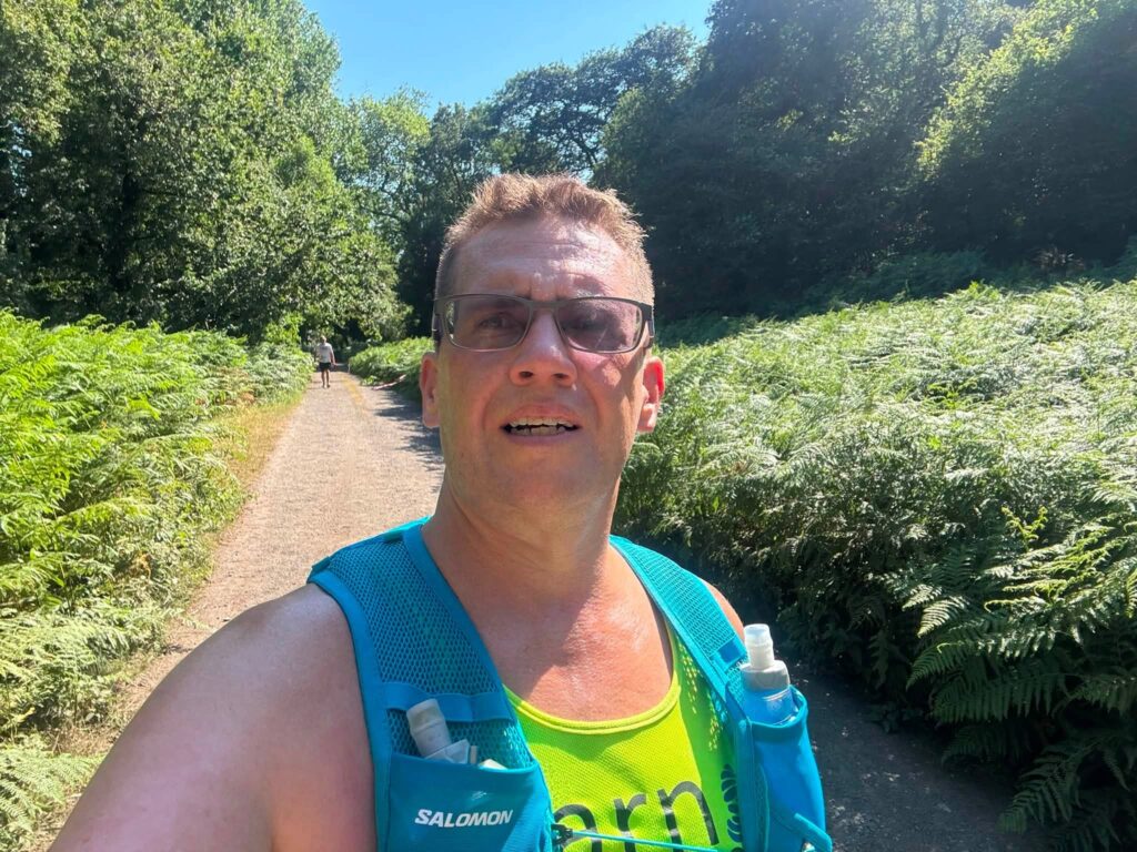 David Vaughan proudly displaying his Hope Trail Festival finisher's medal after completing 40 miles