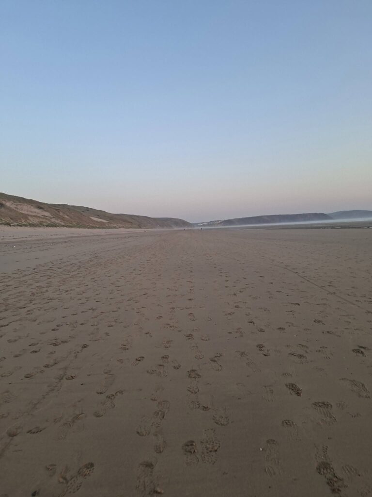 Claire running the Sunset Summer Long 10K along the coast from Crantock Bay to Perranporth