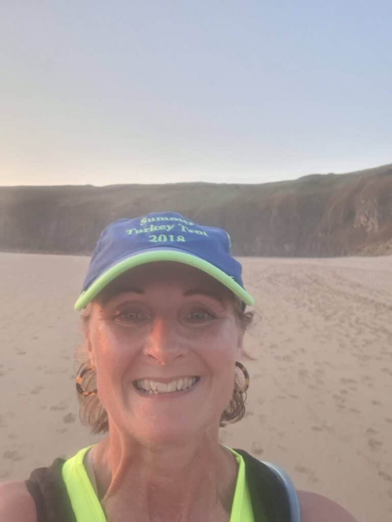 Claire running the Sunset Summer Long 10K along the coast from Crantock Bay to Perranporth