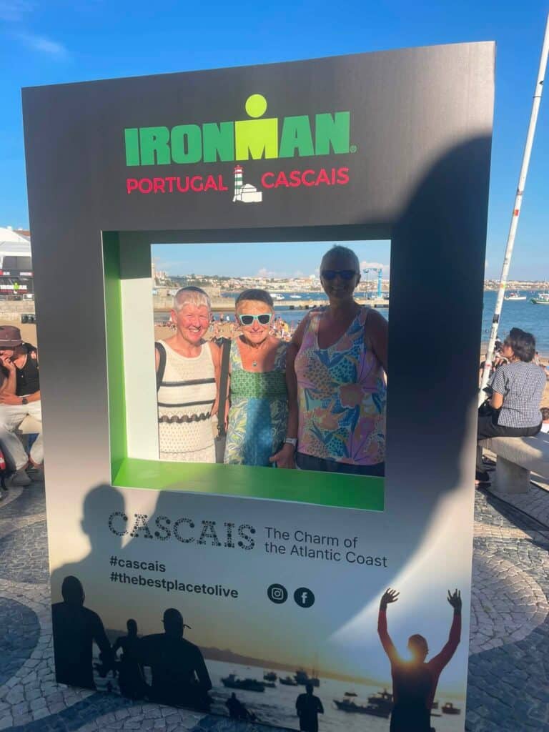 Three relay teammates represented beside a coastal swim, cycle and run setting in Cascais